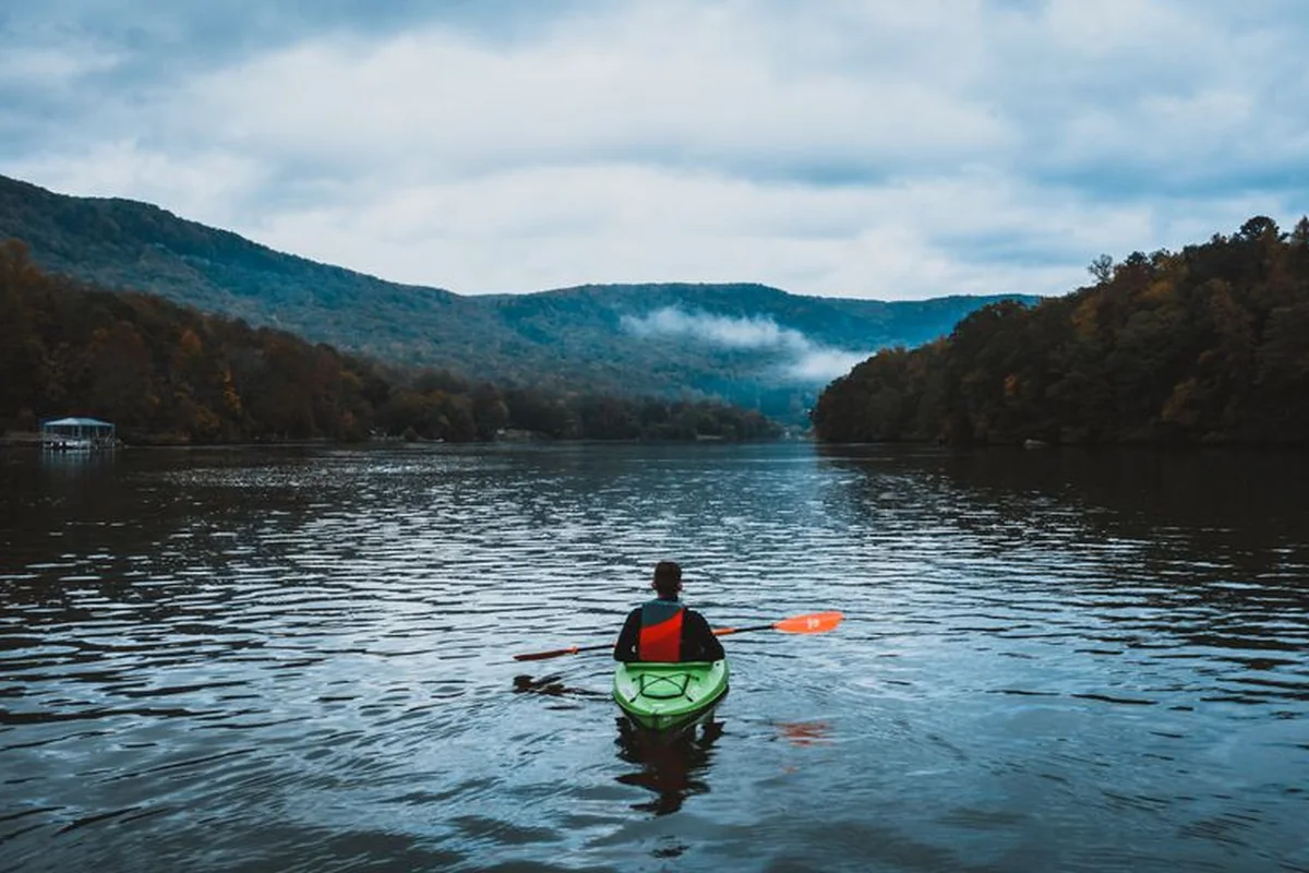 A kayaker crossing a calm lake