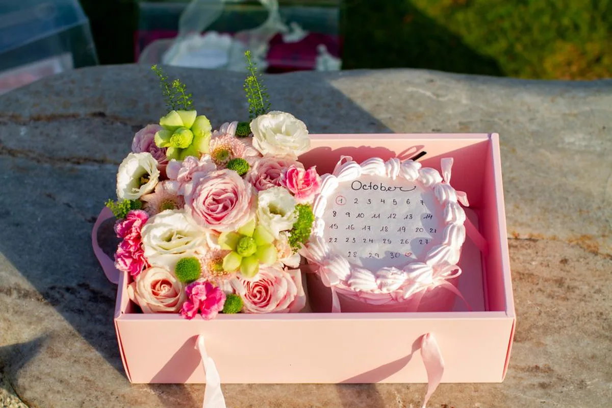 Flowers arranged in a pink delivery box